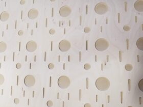 CNC machined wood panel with decorative hole pattern